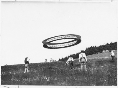 A Wheel-Shaped Kite Flies as its Inventor, Alexander G Bell, Watches