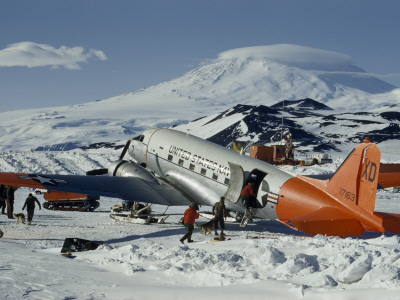 Men Leading Sled Dogs to Waiting Transport Plane