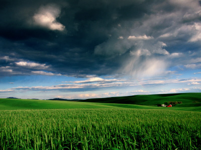 Red Barn in Field with Storm Clouds.