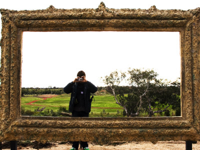 Buy Man Taking Photo Inside Giant Frame Overlooking Werribee Open Range Zoo at AllPosters.com