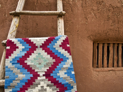 Woven Mat with Native American Indian Motif Against Mud-Brick Wall