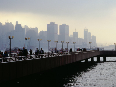 People on the Esplanade, and a View of Hong Kong Island Shrouded in a Twilight Mis