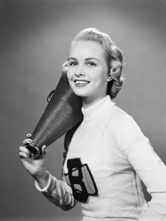 Teenage Girl Wearing Cheerleader Sweater Holding Megaphone Over Shoulder Poster