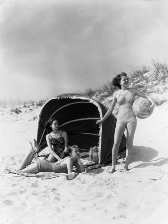 Three Women on Beach, Two Are Under Canvas