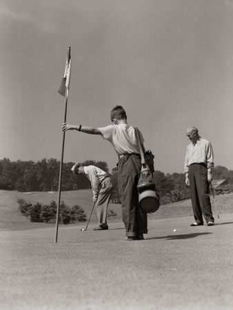 Golfer Getting Ready To Putt With Boy Caddy Poster