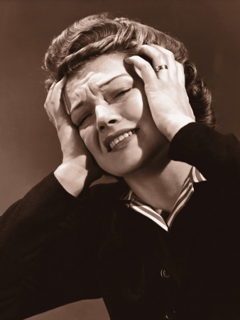 Woman Clutching Her Head in Pain, With Both Hands