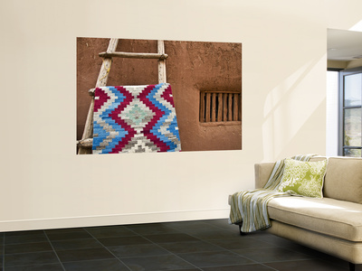 Woven Mat with Native American Indian Motif Against Mud-Brick Wall