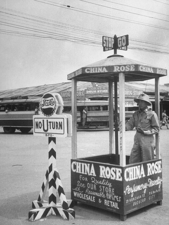 A Pepsi Cola Traffic Sign Standing at the Intersection
