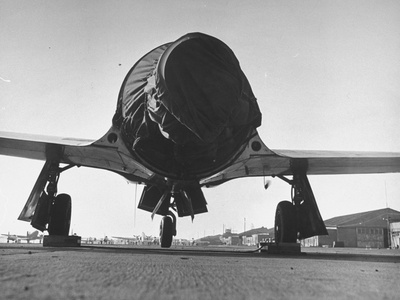 A Black Canvas Protective Shroud Covering the Bare Engine of a P-80 Fighter Plane