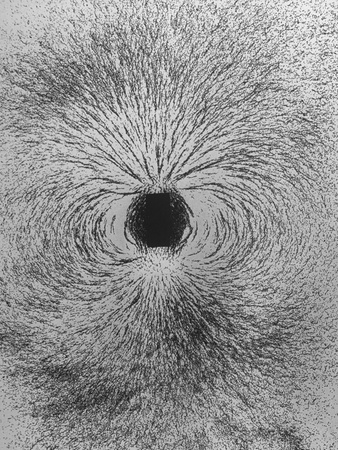 Pattern Made by a Magnetic Field, Made Visible by Iron Filings Surrounding Rectangular Magnet