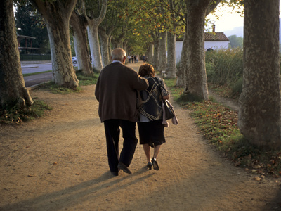 Buy An Elderly Couple Walking Along a Tree-Lined Dirt Road at AllPosters.com