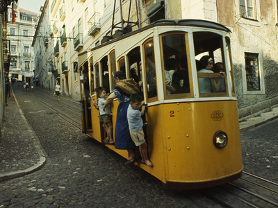 High Quarter Jam-Packed Cable Trolly Descends a Cobblestoned Street