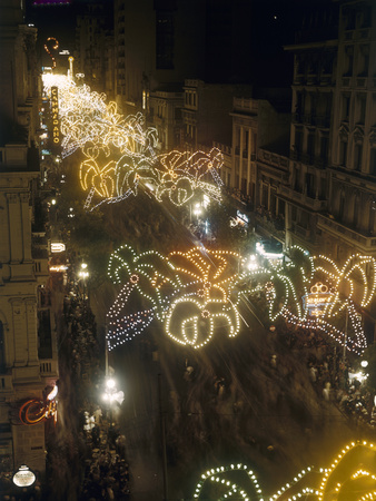 Buy Festive Lights Span across Buildings over Pedestrians on the Street at AllPosters.com