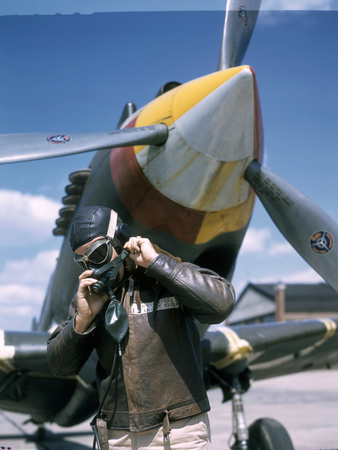 Buy A Pilot Adjusts His Oxygen Mask in Front of an Airplane at AllPosters.com