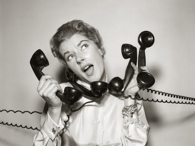 1950s 1960s Overwhelmed Stressed Woman Answering Four Black Telephone Phone Receivers At One Time