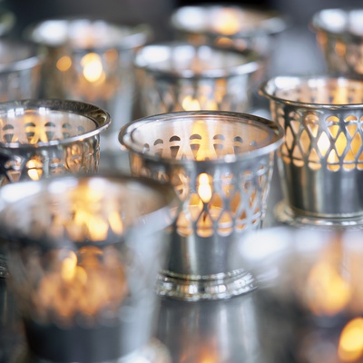 Many Votive Candles in Silver Holders