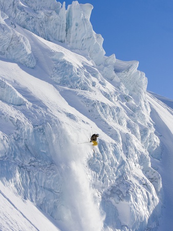 Skier going over edge of cliff