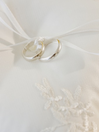 Close up of wedding rings on pillow