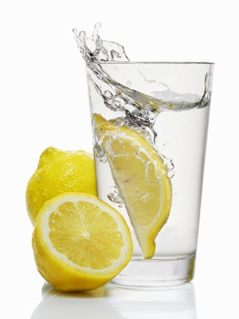 A Wedge of Lemon Falling into a Glass of Water