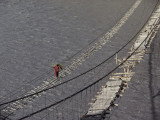 Buy A Hunzukut Woman Crosses a Footbridge over the Hunza River at AllPosters.com