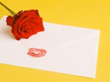 Envelope with lipstick kiss, red rose
