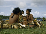 Buy Two Young Women Talk While an Infant Sits Between Them at AllPosters.com