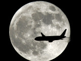 Jet Plane Passes in Front of the Full Moon Above Surfside, Florida