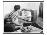 Young Woman with Short Dark Hair Wearing a Stripy Mini Dress Adjusts Her Television Set