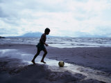 Buy Boy Kicking Soccer Ball on Beach, Lake Nicaragua, Granada, Nicaragua at AllPosters.com