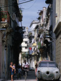 Buy Woman with Baby, Man on Bicycle and Old Car in a Narrow Street Lined with Houses, Havana, Cuba at AllPosters.com