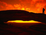 Buy Silhouette of a Hiker on Mesa Arch Against a Spectacular Orange Sky, Utah, USA at AllPosters.com