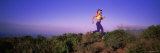 Young Woman Running on a Hill