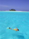 Buy Woman Snorkelling at Sea Surface,Cocos Keeling Island in Background, Indian Ocean, Australia at AllPosters.com