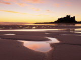 Buy Bamburgh Castle in Silhouette at Sunrise, with Rock Pools on Empty Beach, Northumberland, England at AllPosters.com