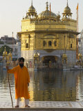 Buy Shrine Guard in Orange Clothes Holding Lance Standing by Pool in Front of the Golden Temple at AllPosters.com