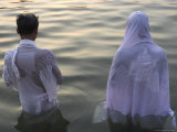 Buy Two Pilgrims in White Dress Making Puja Celebration in the Pichola Lake at Sunset, Udaipur, India at AllPosters.com