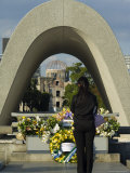 Girl Praying at Cenotaph, a Bomb Dome, Peace Park, Hiroshima City, Western Japan
