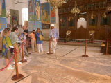 Tourists and Guide Looking at Mosaic Map Dating from 560 AD, St. George's Church, Madaba, Jordan