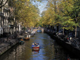 Small Boat on Tree-Lined Oudezijds Achtenburg Wal Canal in the Autumn, Amsterdam, the Netherlands