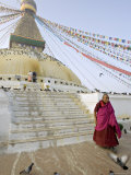 Buy Buddhist Monk Descends the Steps of Boudha, the Tibetan Stupa in Kathmandu, Nepal at AllPosters.com