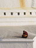 Tibetan Buddhist Monk Reading Scriptures at the Boudha Stupa at Bodhanath, Kathmandu, Nepal