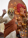 Holy Man in Front of a Ganesh Statue Draped in Fairy Lights at the Hindu Festival of Shivaratri