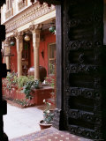 Traditional Wood Door and 19th Century Floor Tiles in Restored Traditional Pol House
