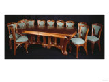 A Highly Important Carved Mahogany Dining Table and Chairs