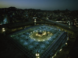 Thousands of pilgrims circle the Kaaba in illuminated view at night