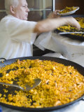 Buy Man Serving Paella, with Noodle Paella in Foreground, Central, Valencia, Spain at AllPosters.com