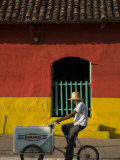 Ice Cream Vendor Riding Bicycle Past Colourful House, Granada, Nicaragua