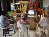 Buy Men Catching Up on Television in City Commercial Centre in Belize, Belize City, Belize at AllPosters.com
