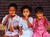 Buy Three Children Eating Icy-Poles, Bengali Basti, Delhi, India at AllPosters.com