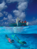 Female Divers Submerged Below Catamaran Photographic Print